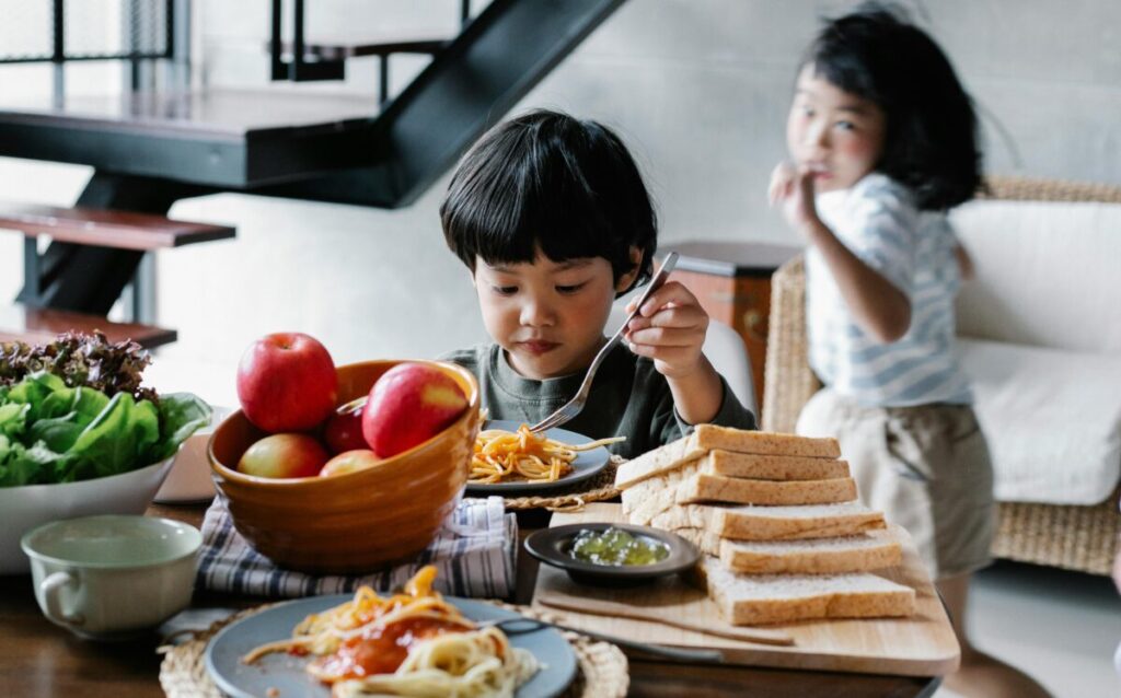 A baby enjoying a nutritious midday meal, showing a healthy alternative to adding cereal to bottle to help baby sleep.