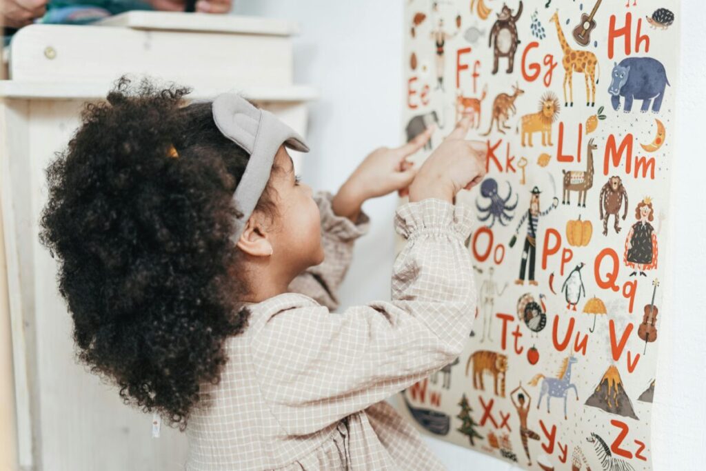 A toddler standing by a growth chart illustrating the growth slowdown after 12 months