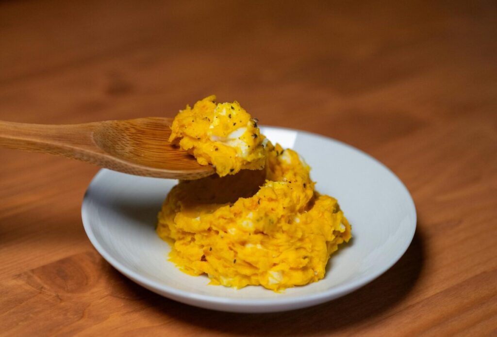 Close up of lumpy food textures for a 7-month-old baby feeding schedule to practice chewing
