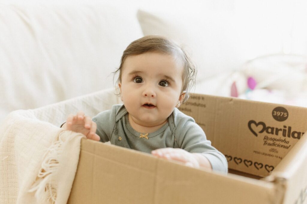 Close-up of a 5-month-old baby during a mirror date, one of the fun 5 month old baby activities that helps with self-recognition