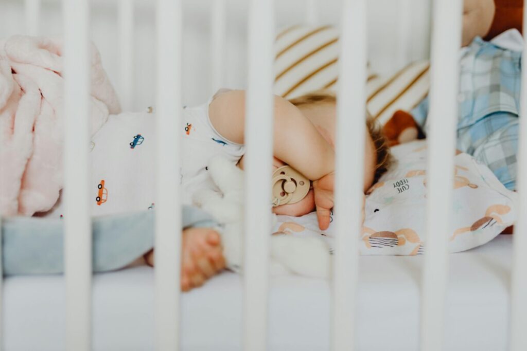 An infant sleeping peacefully through the night, proving that a balanced schedule works better than baby sleep myths cereal in bottle.