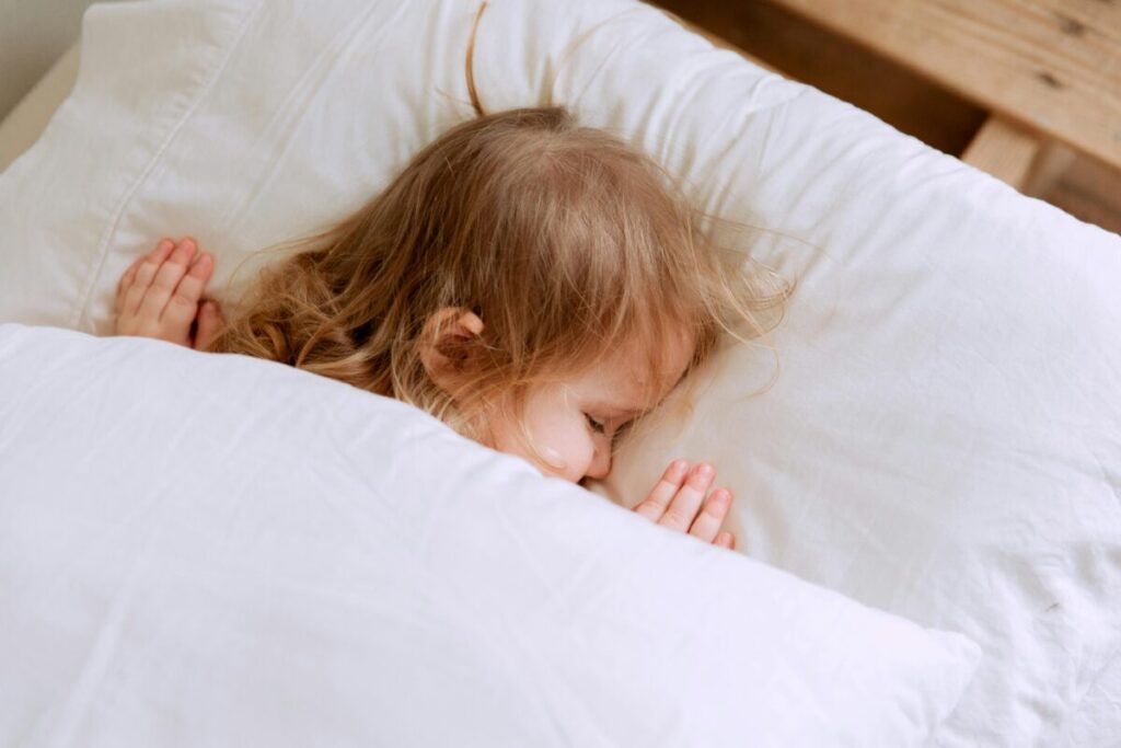 A peaceful toddler sleeping soundly to support their immune system shield during daycare cold and flu season