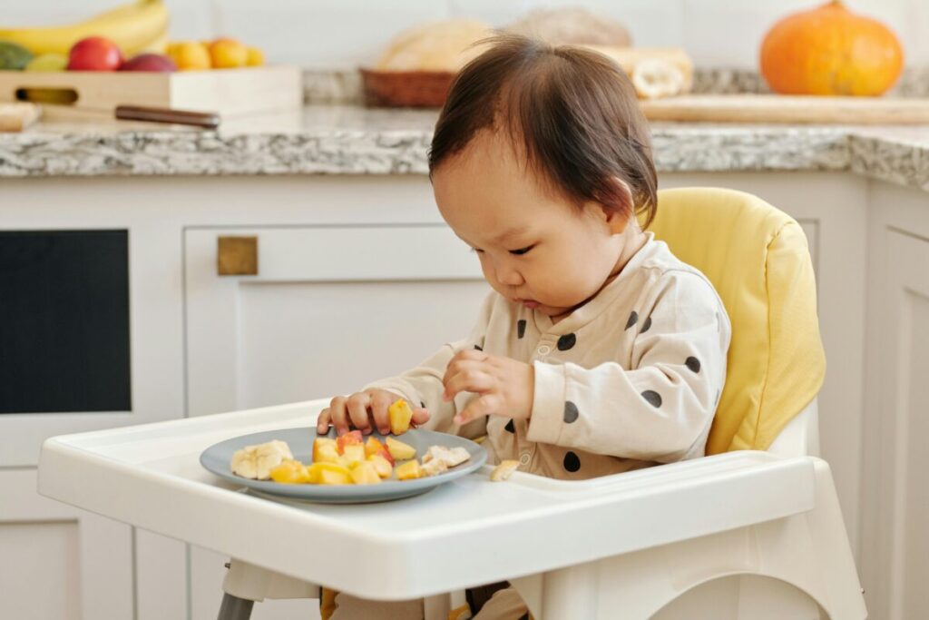 A toddler deciding how much to eat as part of the division of responsibility method