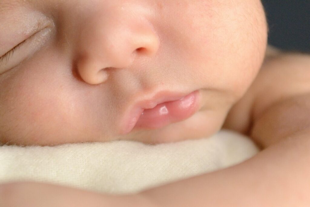A peaceful infant sleeping soundly, debunking common baby sleep myths cereal in bottle for long rest.