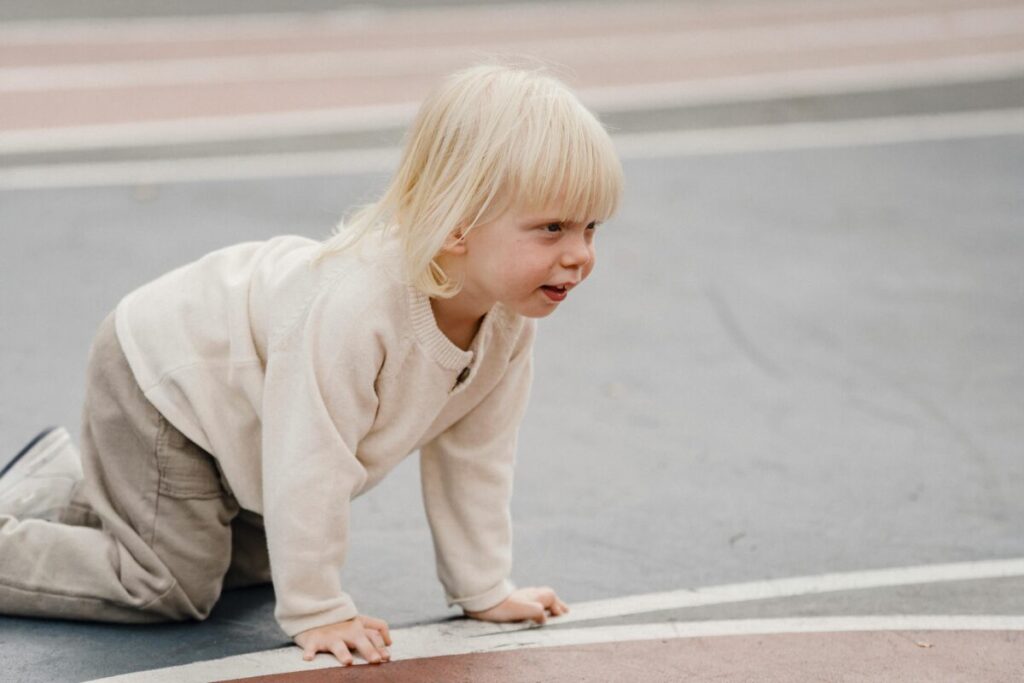 Frustrated toddler throwing a tantrum on the kitchen floor experiencing 24 month old behavior