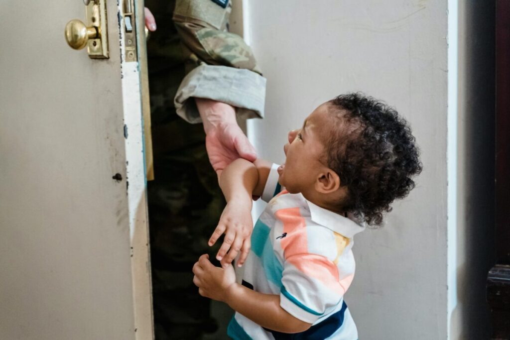 A toddler experiencing distress during a goodbye ritual, illustrating how to handle 21 month old separation anxiety gently