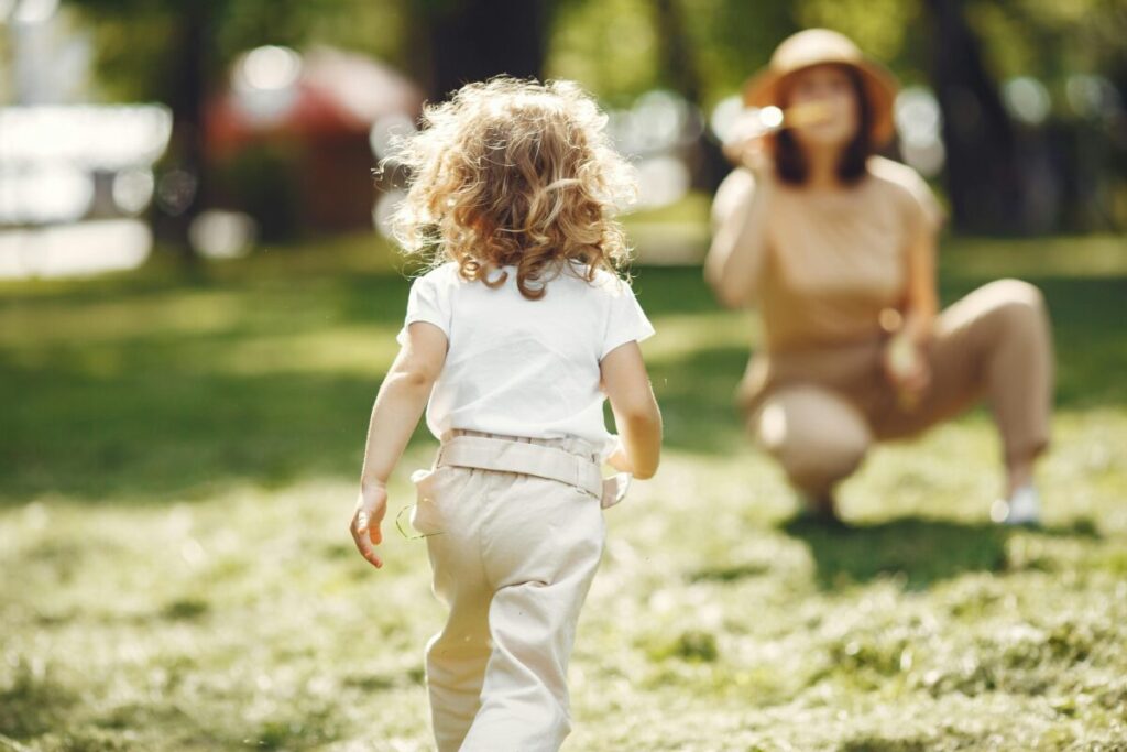 Toddler exploring 18 month old developmental milestones while playing