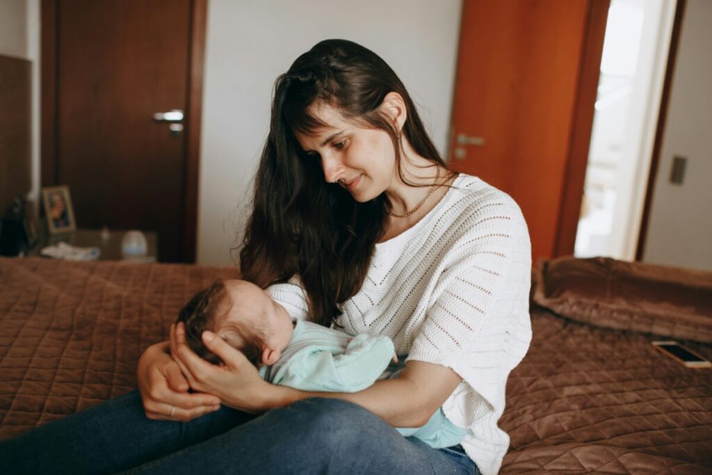 A tired mother managing the home office while following a one nap transition survival guide for her toddler