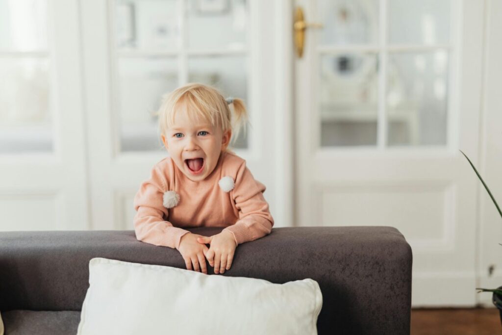 A funny toddler talking loudly and making facial expressions, showcasing the expressive 21 month old toddler vocabulary explosion