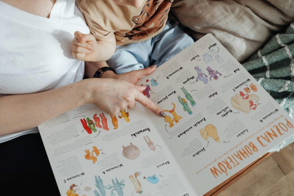 An inquisitive child pointing at pictures in a book, demonstrating the rapid 21 month old toddler vocabulary explosion.