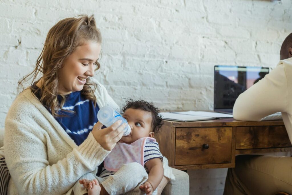 A working mother using a breast pump at her desk, practical tips for breastfeeding while working