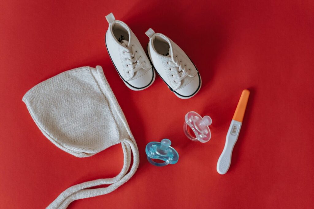 Realistic second trimester essentials for moms to be including a pregnancy journal and baby gear.