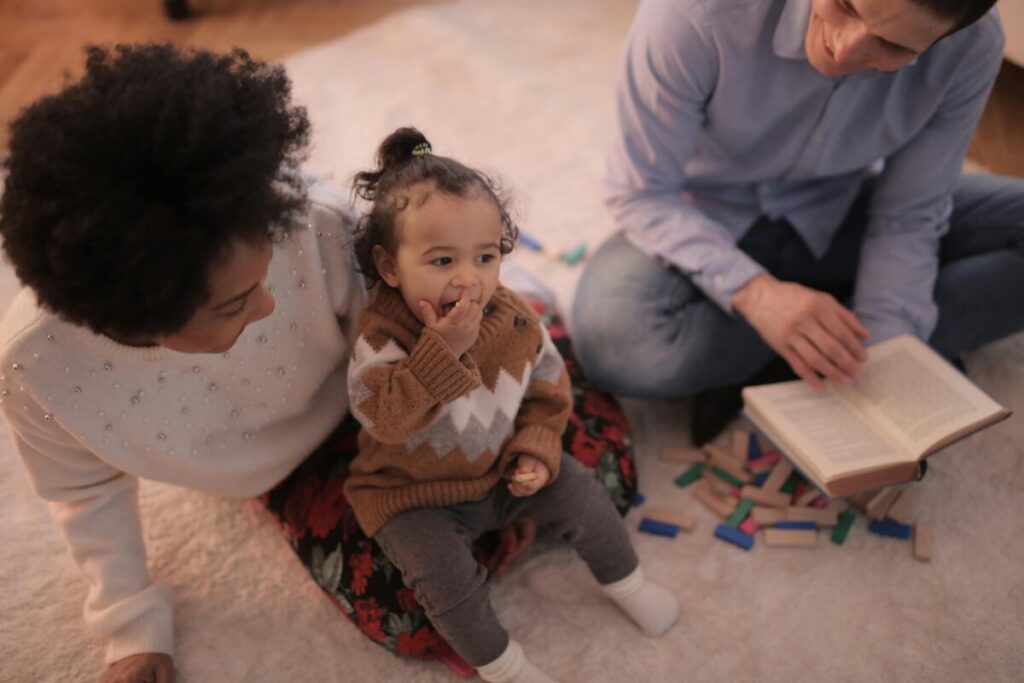 An exhausted mother comforting her twenty-month-old toddler during a tantrum on the living room floor, illustrating a brutally honest survival guide to 20 month milestones.