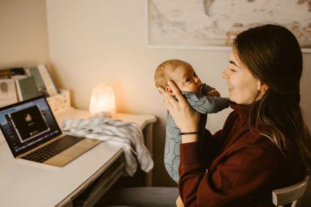 Mother hugging her baby after a workday, balancing work and motherhood transition at home