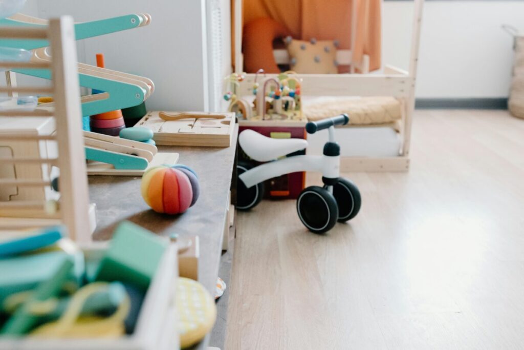 An organized living room with toys neatly sorted in bins, before a toddler gets hold of their healthy finger foods for 14 month old meals.