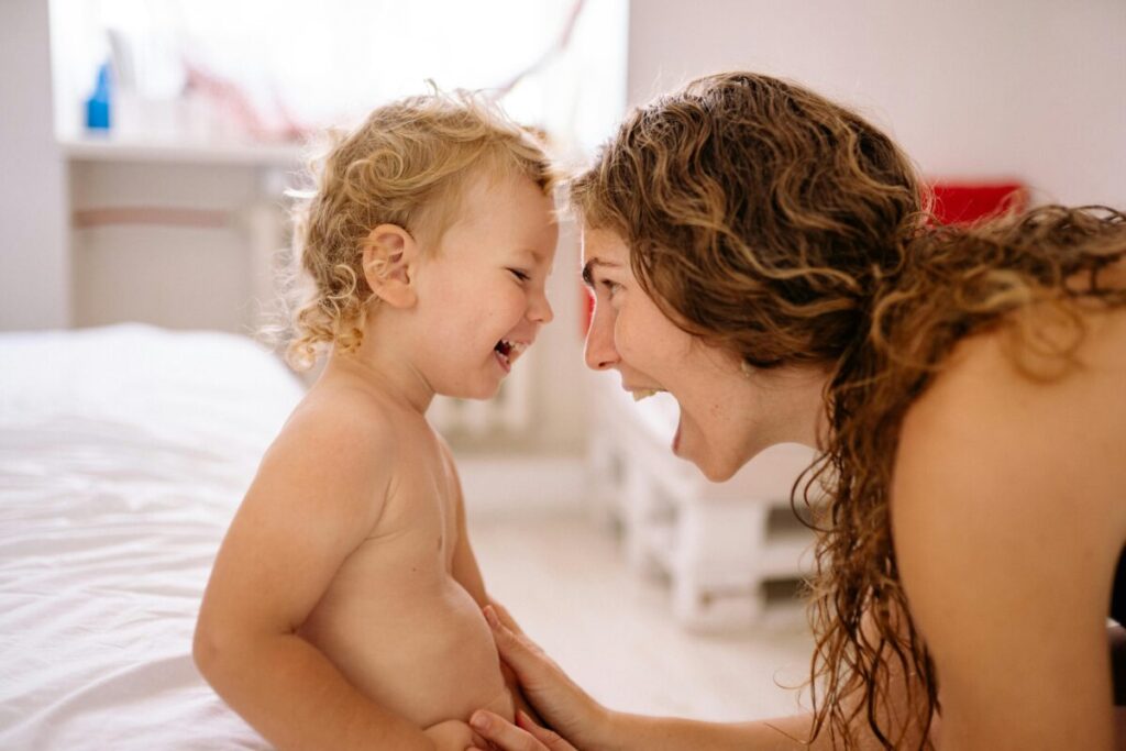 Parent using gentle discipline for toddlers while teaching toddlers empathy through eye-level connection