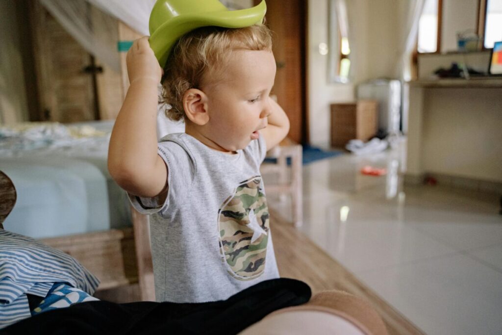 An honest look at 21 month milestones, capturing a messy toddler playing on the floor and testing emotional boundaries.