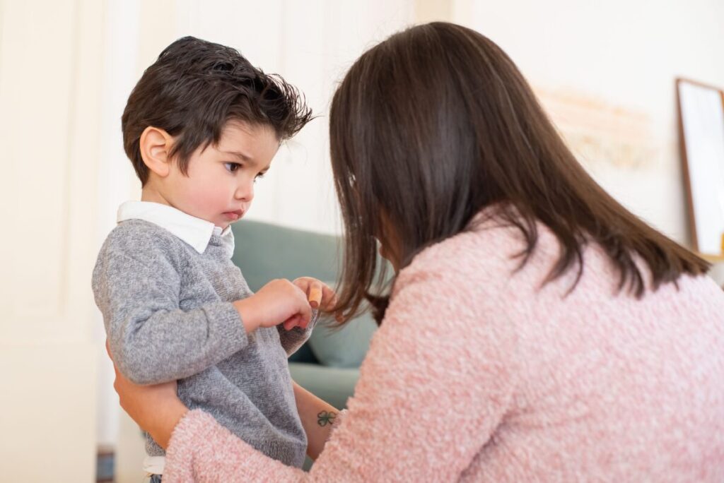 A happy toddler excitedly talking and pointing to his mother, representing the 2-year-old speech explosion and language development.