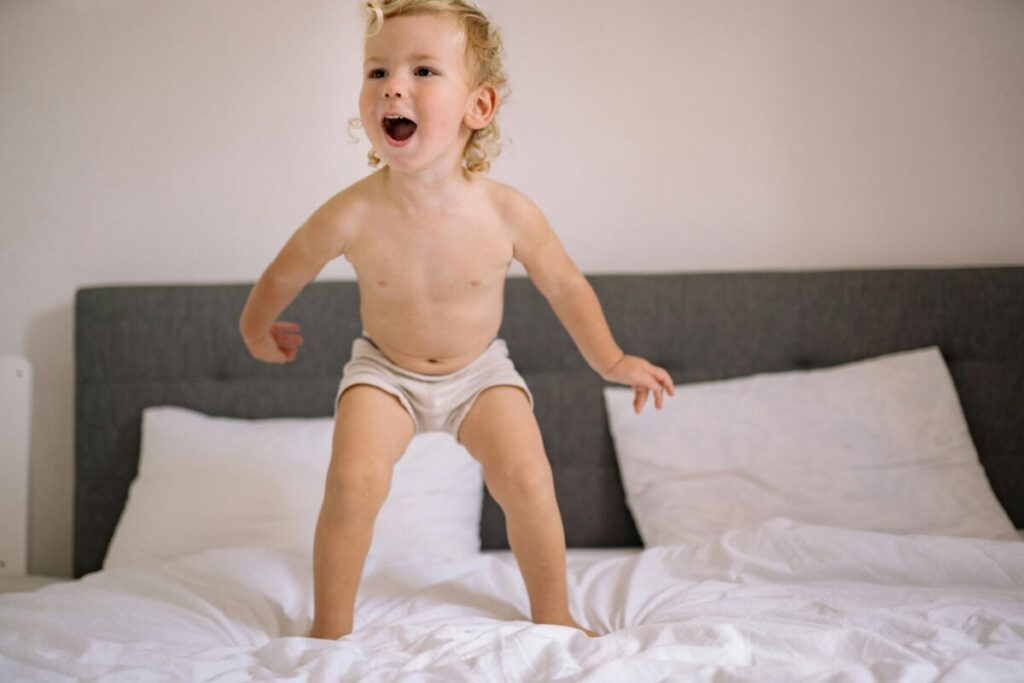 Toddler making the crib to bed transition in a safe nursery room