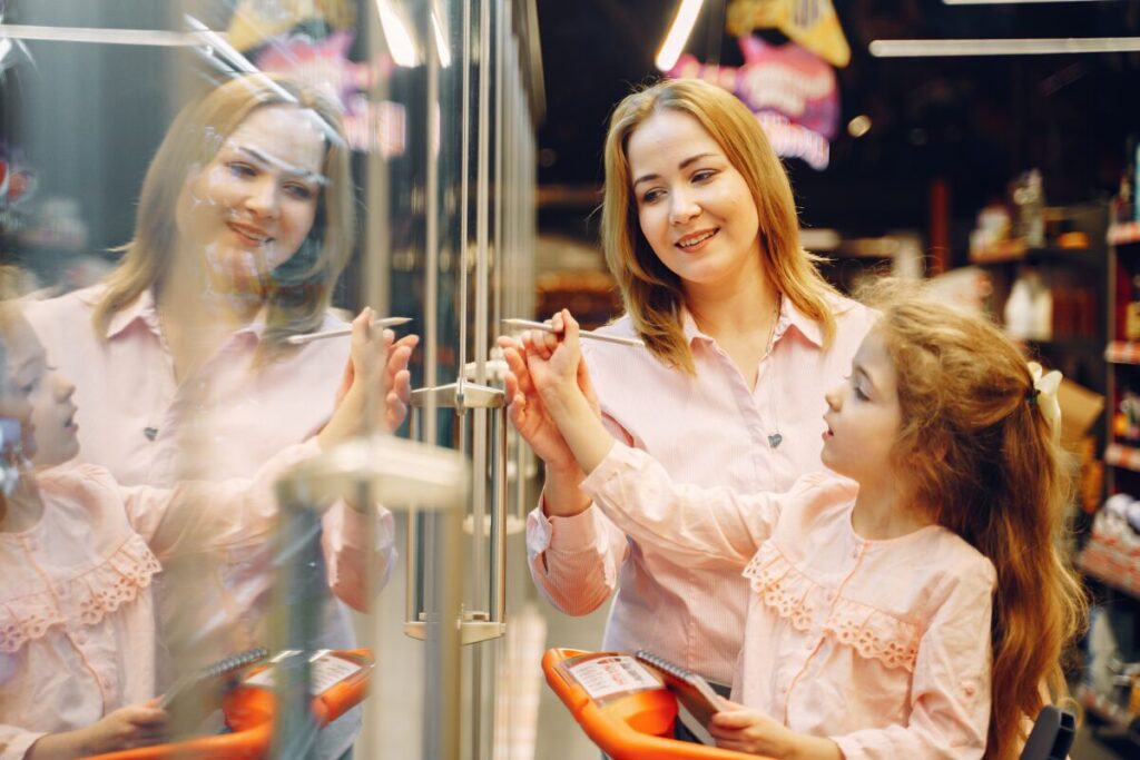 Parent calmly managing a toddler public meltdown in a grocery store aisle while remaining patient