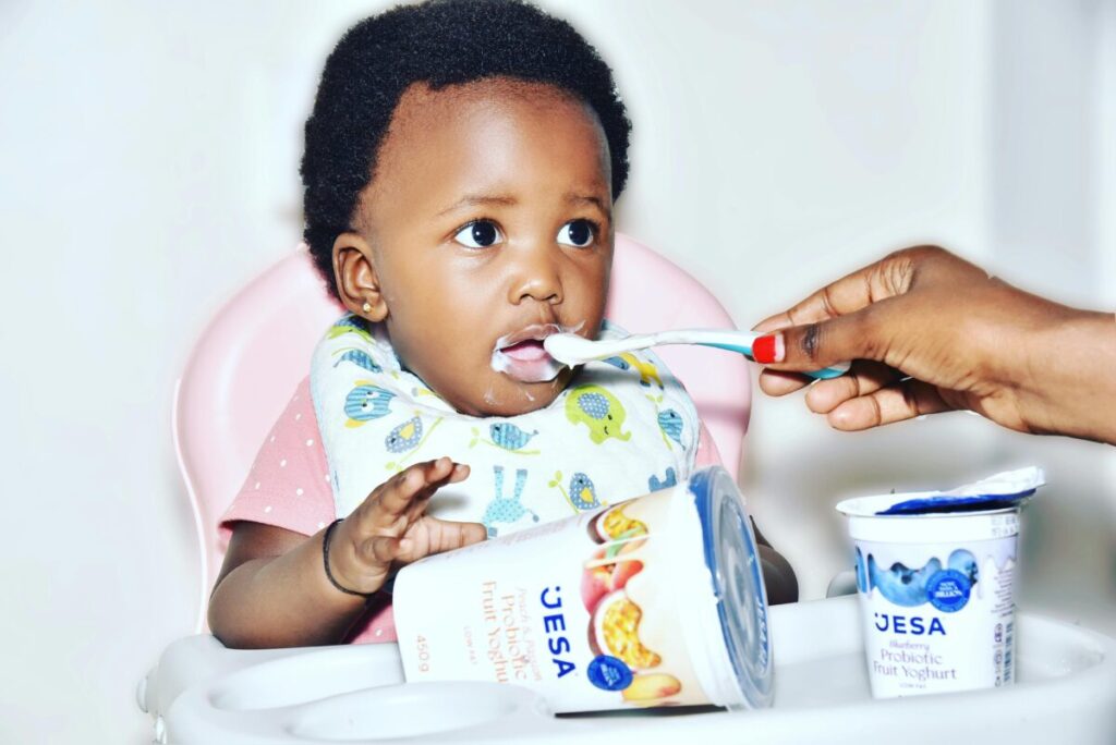 A baby refusing food suddenly with a tightly closed mouth, showing clear signs baby is full