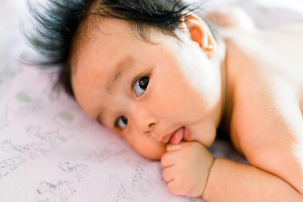 A baby safely learning to eat by baby gagging on solids but not choking, demonstrating a natural safety mechanism.