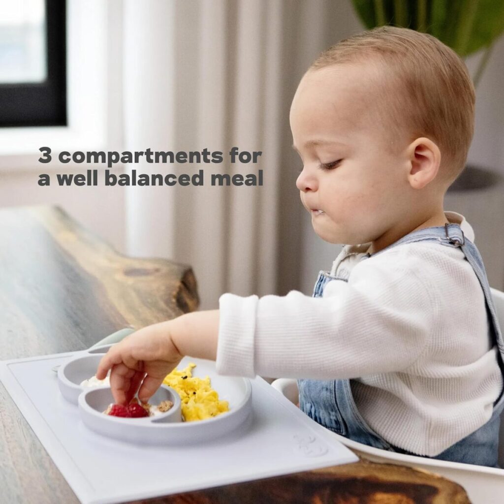 Blush color ezpz Happy Mat silicone suction plate on a high chair, demonstrating easy cleaning and mess control for a messy 16-month-old's feeding routine