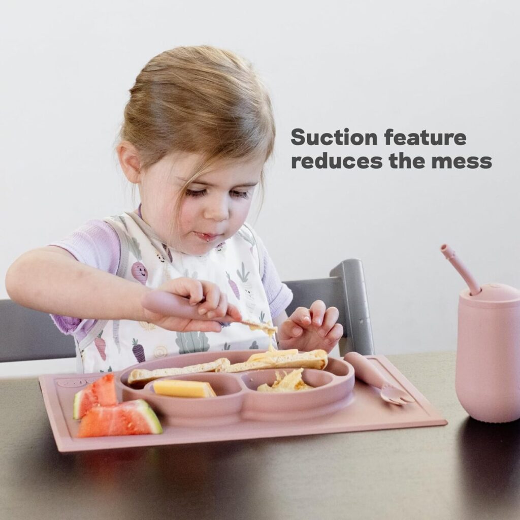 Essential newborn baby gear guide: Baby eating solid foods using an ezpz Happy Mat silicone divided plate