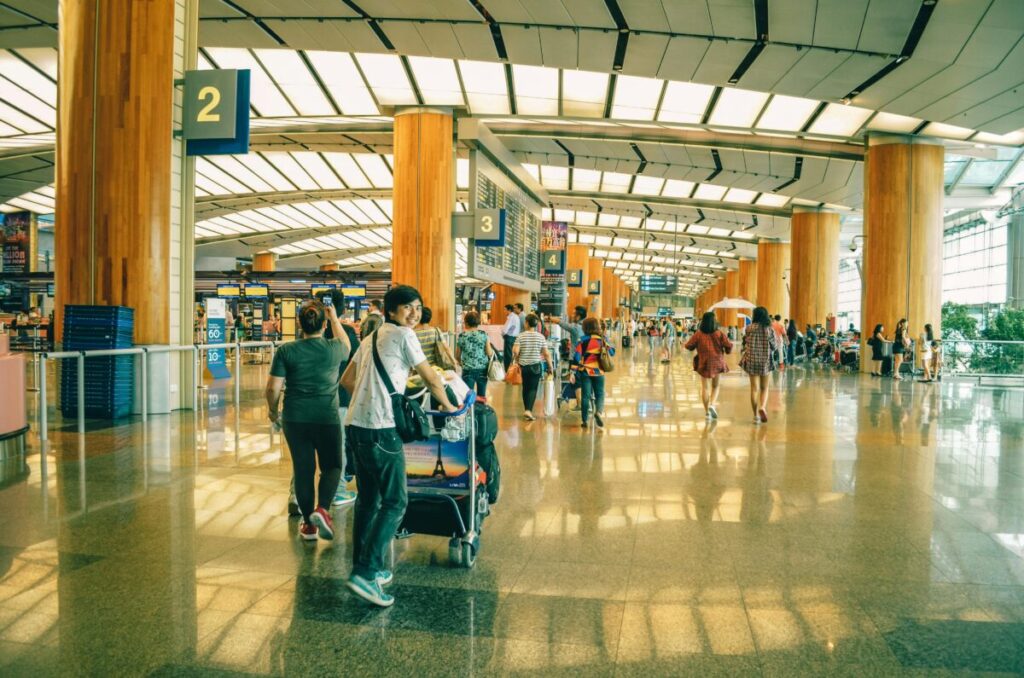 A parent managing a baby sleep schedule while traveling, using essential baby travel gear for international flights and practical tips for flying with an infant alone or with a partner.