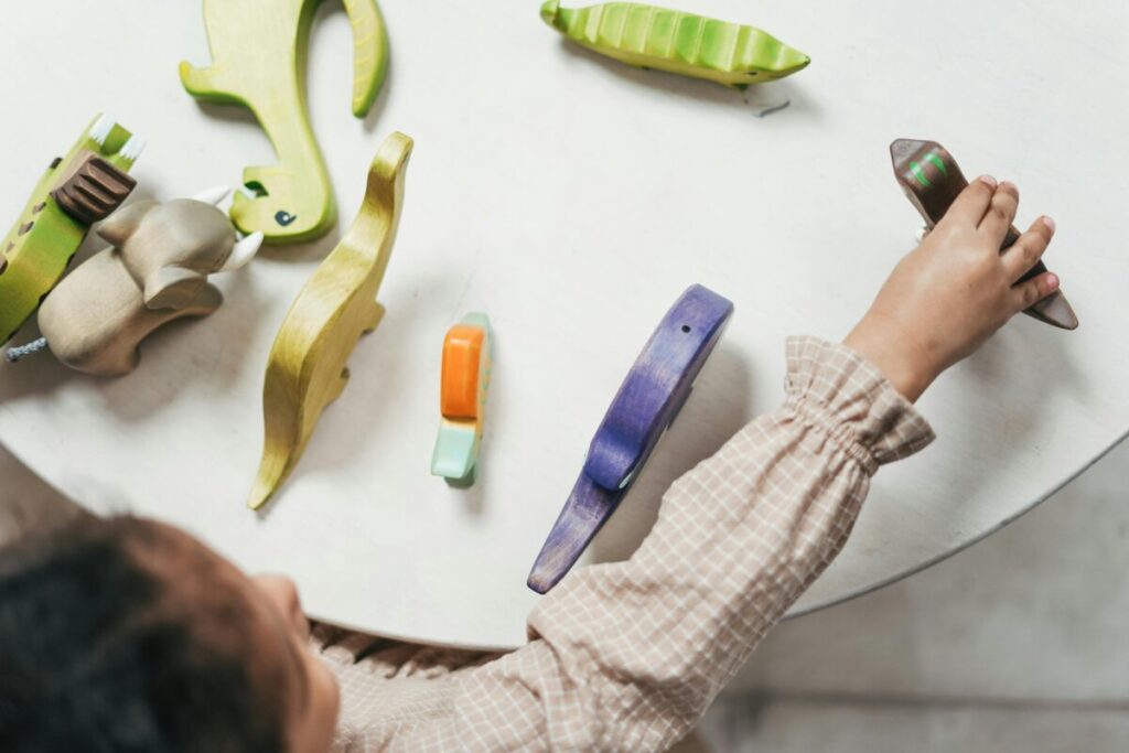 Toddler hugging a toy tightly displaying normal toddler anxiety at 23 months and boundary testing