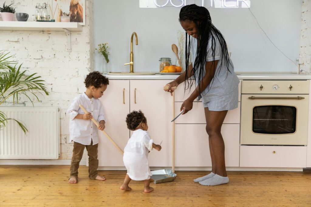 A toddler imitating her mother at home, connecting social play with the language explosion at 19 months milestones checklist