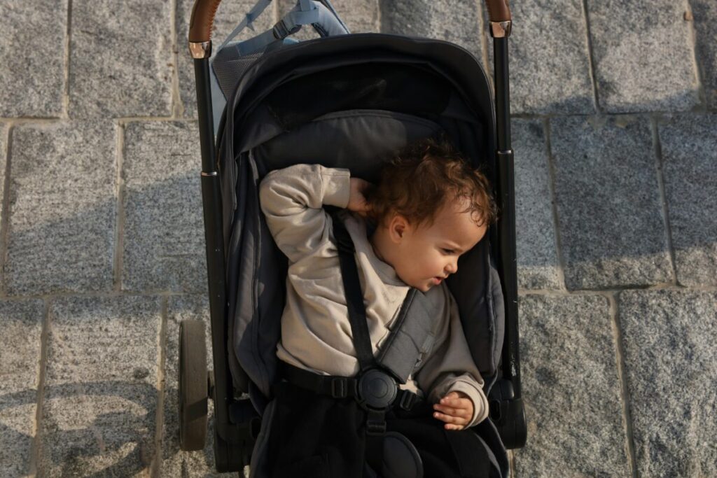 Close up of an infant looking tired to help parents learn how to keep baby hydrated in summer and spot dehydration signs