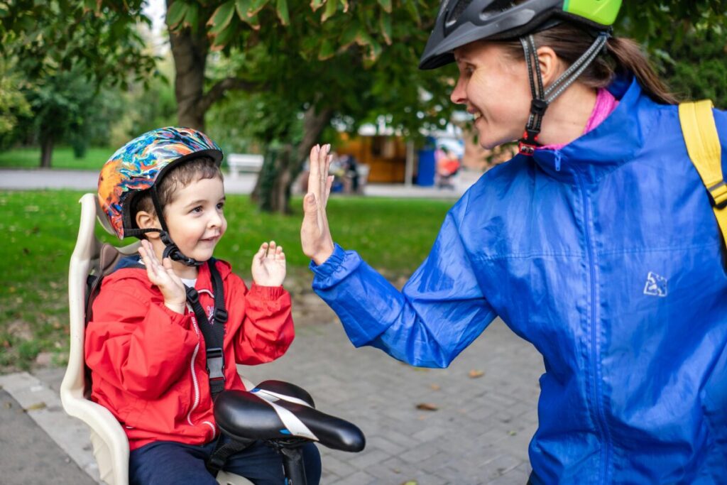 A happy mom giving her toddler a high-five, celebrating success during potty training at 2 years old without bribery