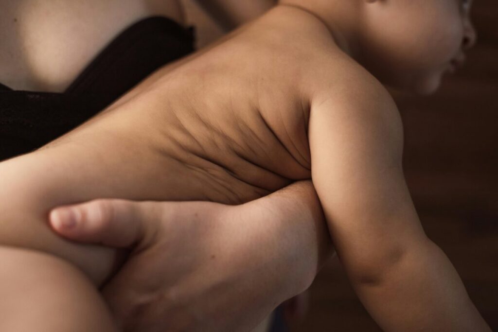 Mother soothing a colicky newborn with skin-to-skin contact, how to relieve baby colic