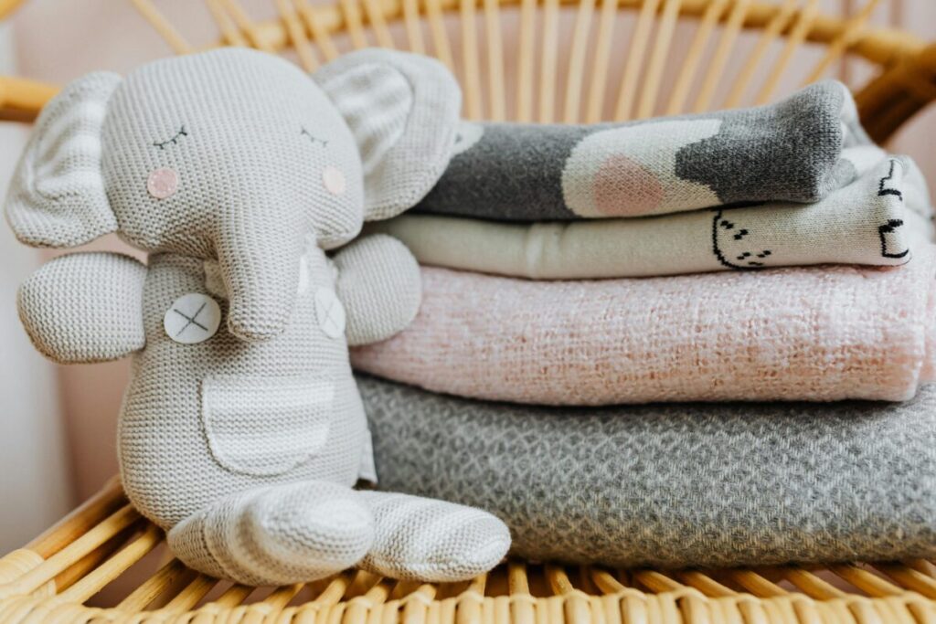 Essential newborn baby gear including a reliable monitor in a minimalist nursery
