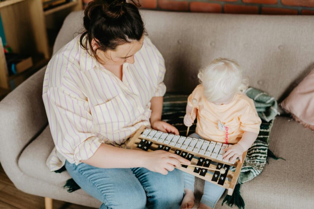 An exhausted mother comforting her crying toddler, tips for surviving the 19 month old sleep regression and tantrums