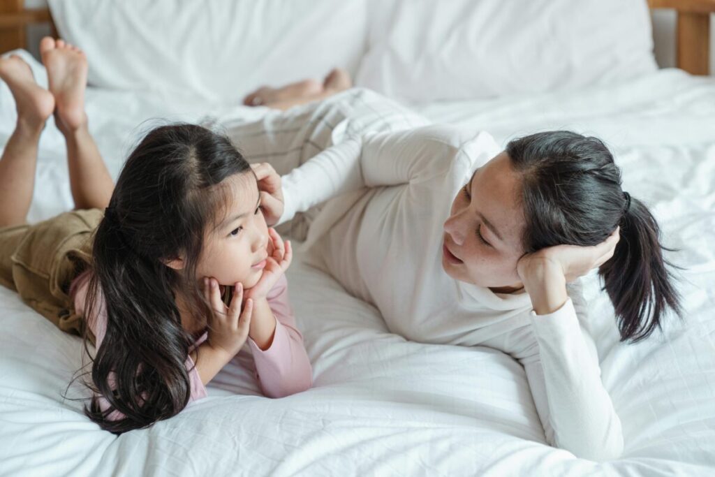 Parent teaching toddlers empathy after a playground incident