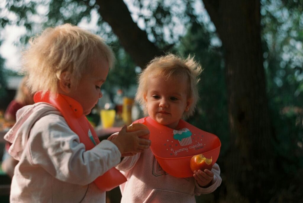 Parent performing the squish test on a soft fruit slice to ensure safe finger foods for babies