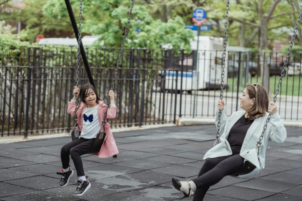 Mother managing toddler sharing struggles calmly at the park