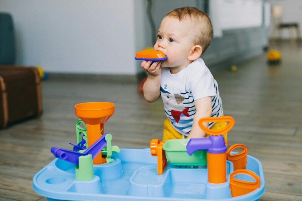 A baby safely using safe teething toys for 6 month old to soothe sore gums.