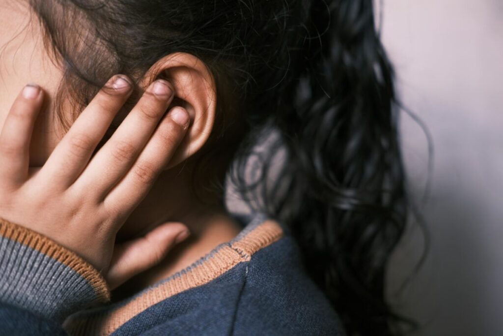 Scared toddler covering ears or crying from loud noise showing toddler anxiety at 23 months
