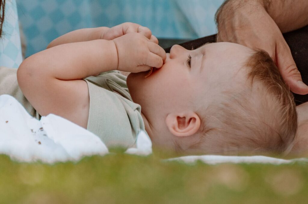 A happy, healthy baby smiling after a baby-led weaning meal, showing no signs of food allergy