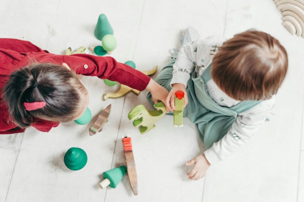 Toddlers playing together in a classroom, highlighting the importance of a nut-free environment for kids with allergies.